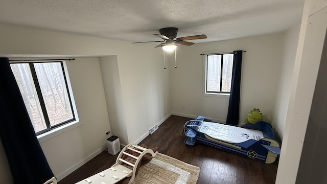 12181 Trail Creek Dr, Stanwood, MI 49346 - bedroom with wood finished floors, a textured ceiling, baseboards, visible vents, and ceiling fan