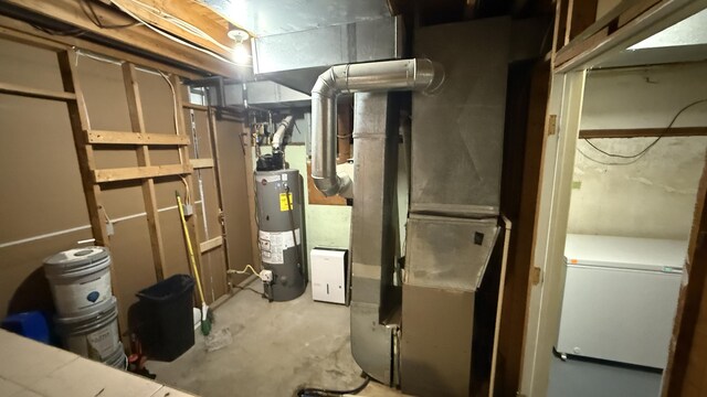 12181 Trail Creek Dr, Stanwood, MI 49346 - utility room featuring water heater and heating unit