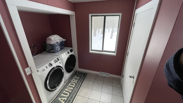 12181 Trail Creek Dr, Stanwood, MI 49346 - washroom with baseboards, visible vents, washing machine and clothes dryer, and light tile patterned floors