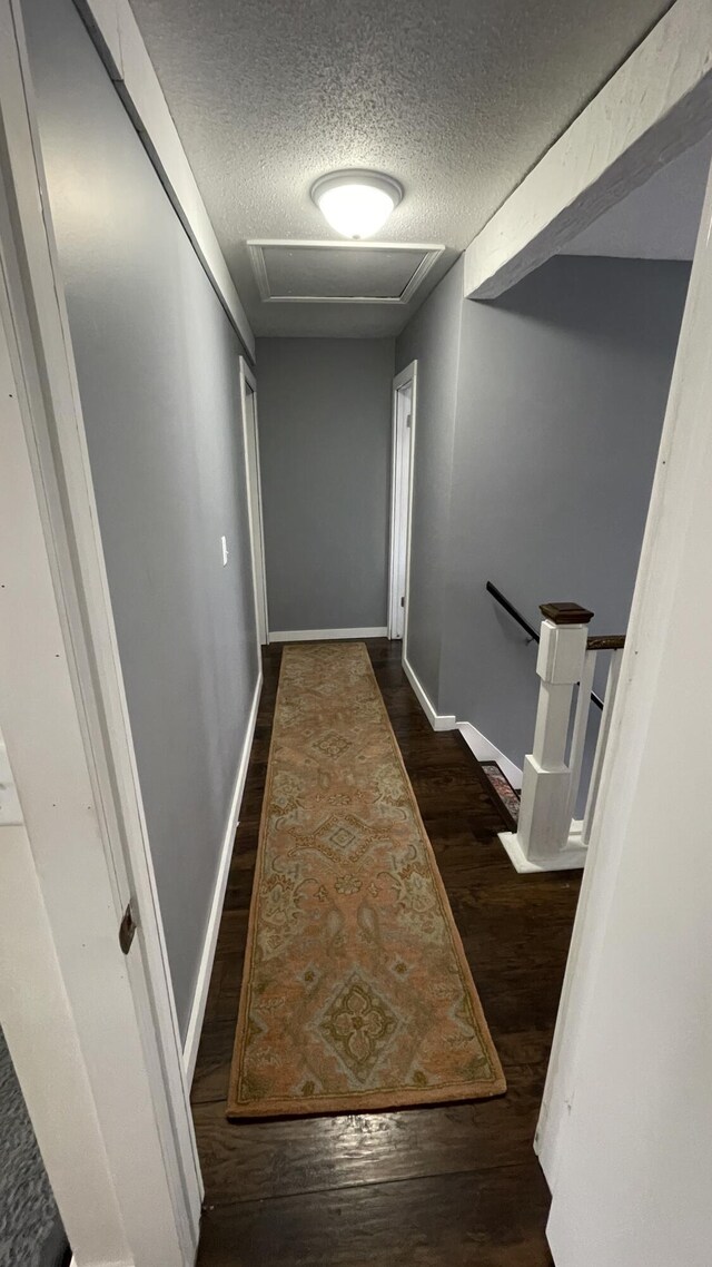 12181 Trail Creek Dr, Stanwood, MI 49346 - hall with baseboards, a textured ceiling, attic access, and wood finished floors