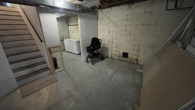 12181 Trail Creek Dr, Stanwood, MI 49346 - unfinished below grade area with refrigerator and stairway