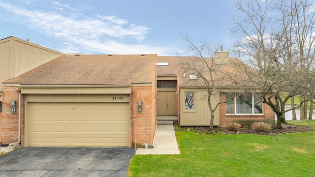 view of front of home with aphalt driveway, a front lawn, brick siding, a shingled roof, and a chimney