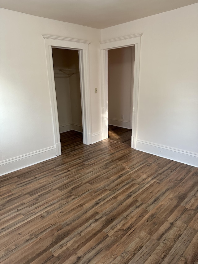 612 Lansing Ave, Jackson, MI 49202 - unfurnished bedroom featuring dark wood finished floors and a closet