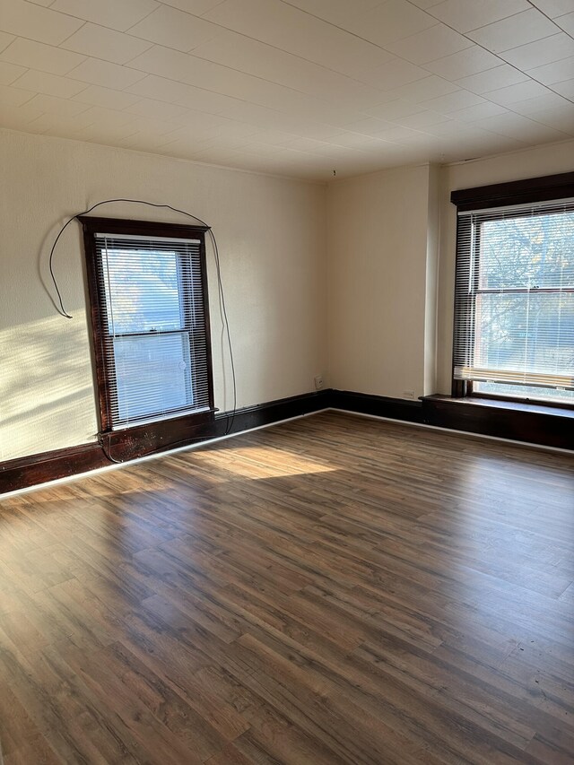 612 Lansing Ave, Jackson, MI 49202 - spare room featuring dark wood-type flooring