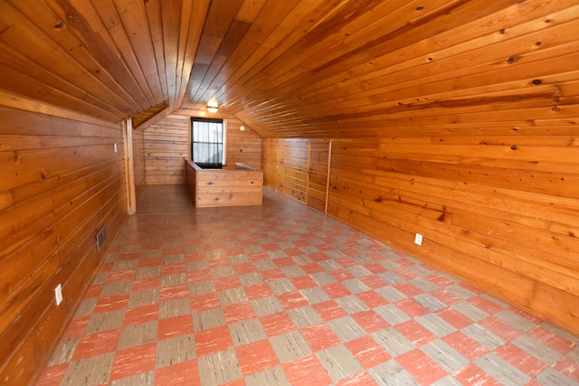 additional living space featuring visible vents, wooden ceiling, wood walls, and vaulted ceiling