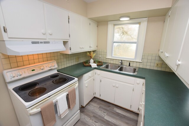 kitchen with white cabinets, white range with electric stovetop, tasteful backsplash, and range hood