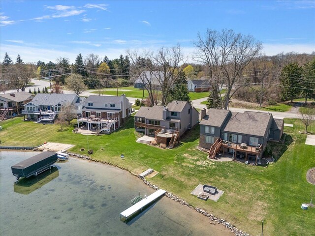 drone / aerial view with a residential view and a water view
