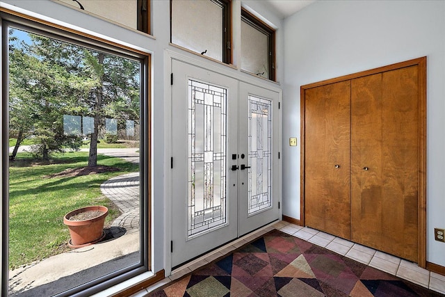 entryway with tile patterned flooring and baseboards