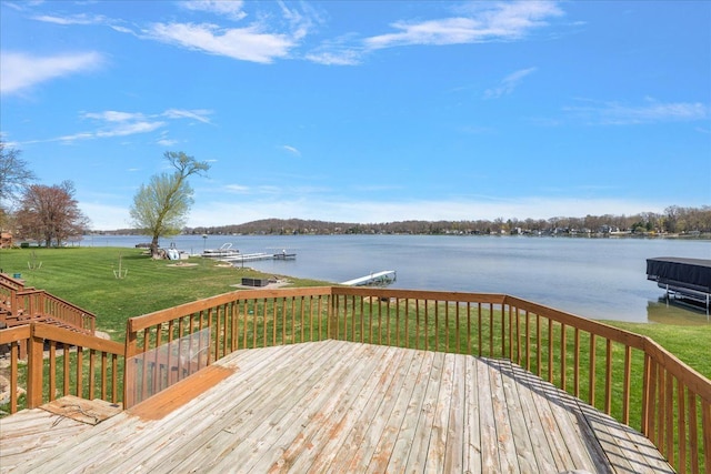 wooden terrace featuring a yard, a dock, a water view, and boat lift