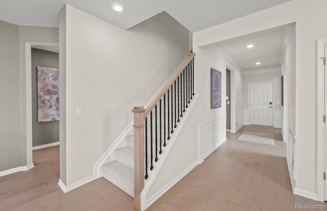 16104 Conifer Ln, Clinton Township, MI 48038 - staircase featuring wood finished floors, a wainscoted wall, and recessed lighting