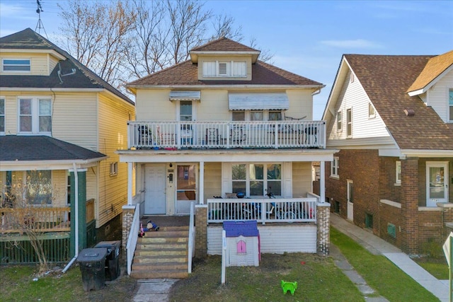 american foursquare style home featuring a porch