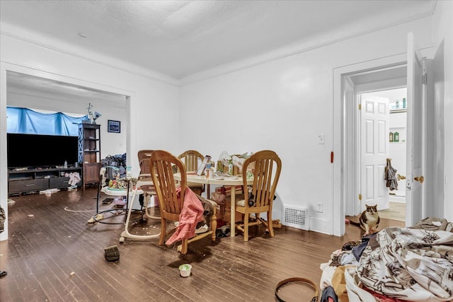 dining space with visible vents and wood finished floors