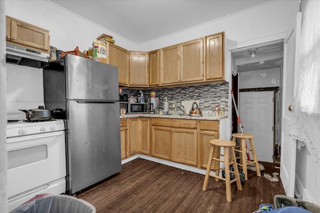 kitchen featuring dark wood-style flooring, ventilation hood, decorative backsplash, and appliances with stainless steel finishes