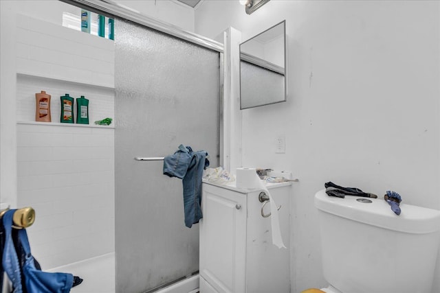 bathroom with a shower stall and toilet