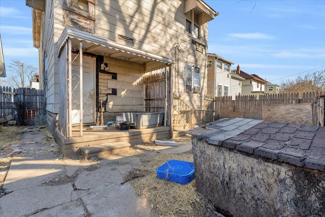 view of property exterior with a residential view and fence