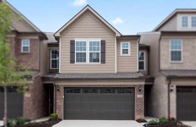 1466 Addison Cir, Walled Lake, MI 48390 - townhome / multi-family property with brick siding, a garage, and driveway