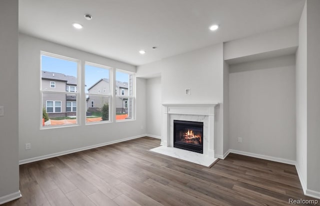 1466 Addison Cir, Walled Lake, MI 48390 - unfurnished living room featuring a premium fireplace, wood finished floors, and recessed lighting
