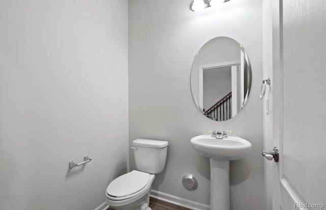 1466 Addison Cir, Walled Lake, MI 48390 - half bath featuring toilet and wood finished floors