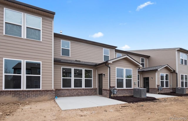 1466 Addison Cir, Walled Lake, MI 48390 - rear view of property featuring brick siding and a patio area