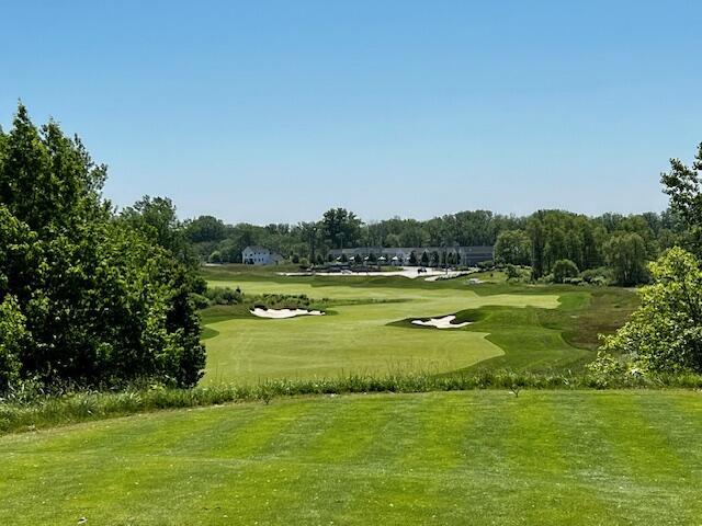 view of community featuring golf course view and a lawn