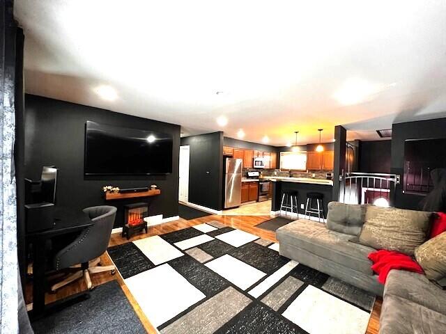 living room with recessed lighting and light wood finished floors