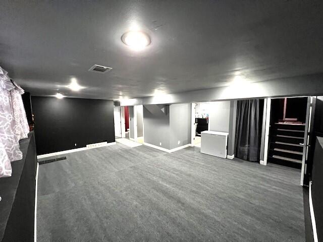 finished basement with baseboards and visible vents