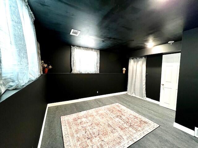 unfurnished room featuring baseboards and visible vents