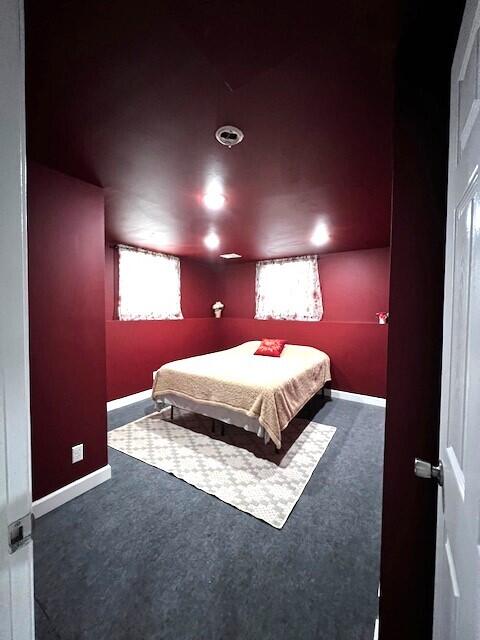 carpeted bedroom featuring baseboards