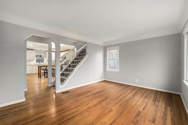 1131 Bauman Ave, Royal Oak, MI 48073 - unfurnished room with baseboards, stairway, and hardwood / wood-style floors