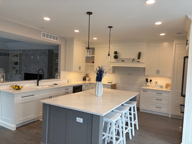 1219 N Main St, Rochester, MI 48307 - kitchen featuring white cabinetry, open shelves, a center island, a sink, and visible vents