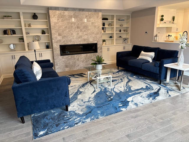 1219 N Main St, Rochester, MI 48307 - living area featuring wood finished floors and a tiled fireplace