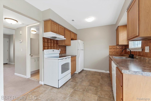 20109 Cumberland, Brownstown, MI 48183 - kitchen with white appliances, under cabinet range hood, backsplash, dark countertops, and brown cabinetry