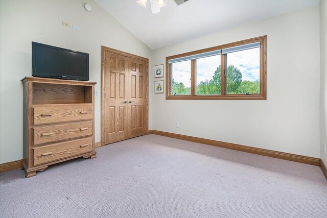 16396 M-89, Augusta, MI 49012 - unfurnished bedroom featuring light carpet, baseboards, vaulted ceiling, and a closet