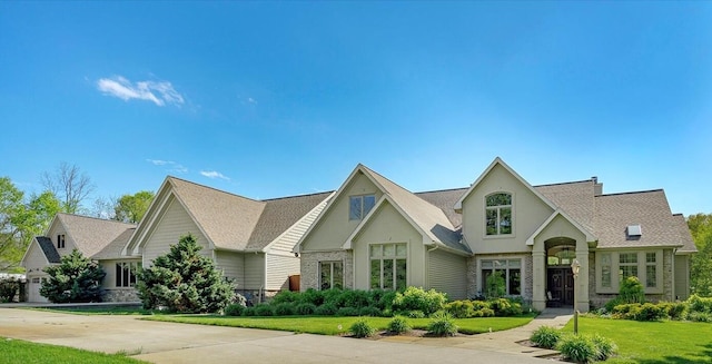 16396 M-89, Augusta, MI 49012 - view of front of home with a front lawn, a shingled roof, stucco siding, and stone siding