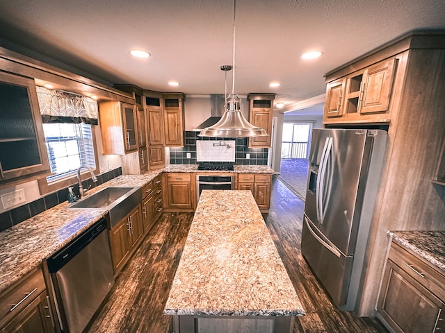 kitchen with glass insert cabinets, a kitchen island, dark wood finished floors, stainless steel appliances, and a sink