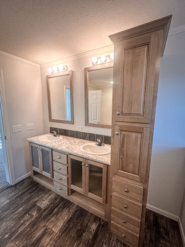 full bath featuring double vanity, a sink, and wood finished floors