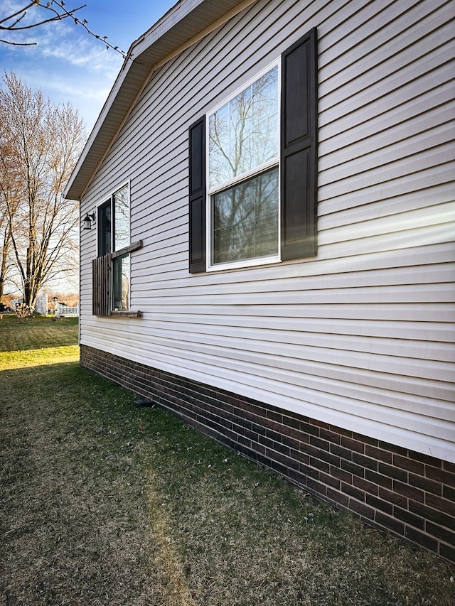 view of side of home with a yard