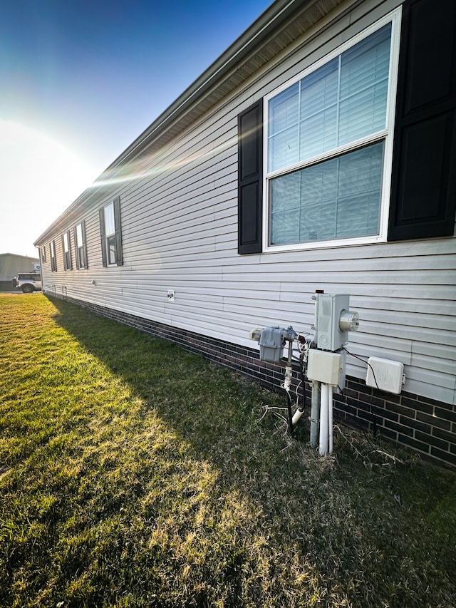 view of side of home with a lawn