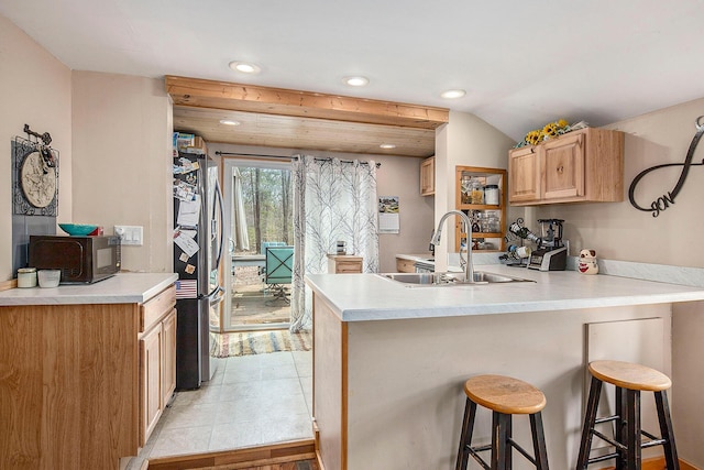 16824 Shawano Dr NE, Sand Lake, MI 49343 - kitchen featuring a sink, a peninsula, recessed lighting, stainless steel fridge with ice dispenser, and light countertops