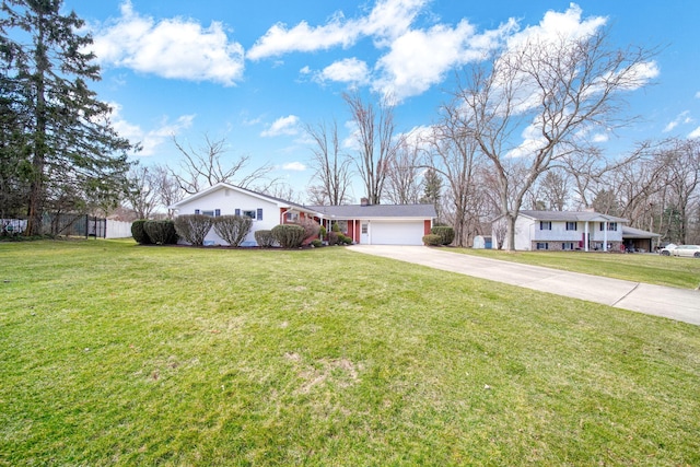 single story home with a front yard, an attached garage, and concrete driveway