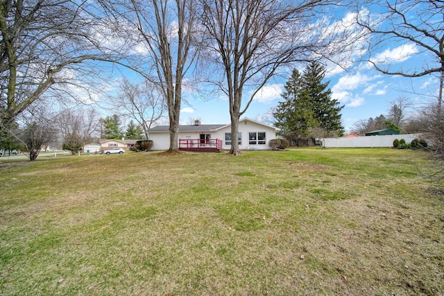 view of yard featuring fence and a wooden deck