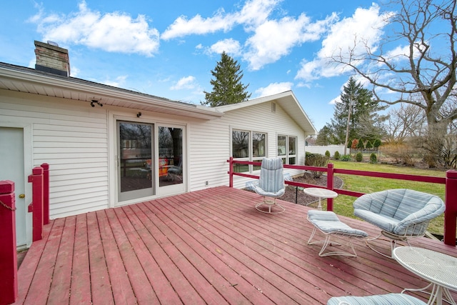 wooden deck with a yard and fence