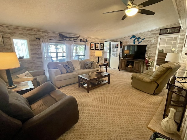 living room featuring light carpet, a textured ceiling, lofted ceiling, and a ceiling fan