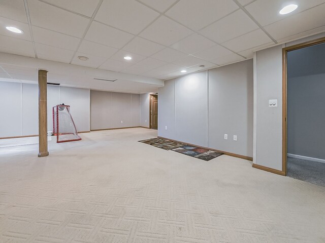 finished basement featuring recessed lighting, baseboards, a drop ceiling, and carpet