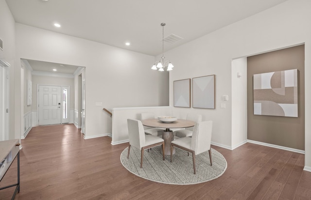 dining area featuring baseboards, a notable chandelier, visible vents, and wood finished floors