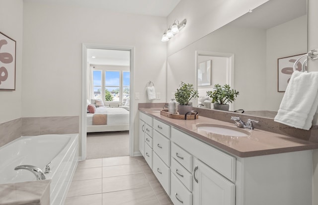 bathroom with a bath, double vanity, a sink, ensuite bath, and tile patterned flooring