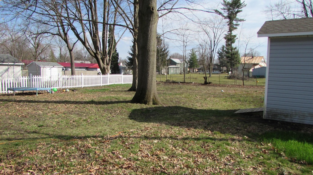 185 Henry St, Coldwater, MI 49036 - view of yard featuring a fenced backyard and a trampoline