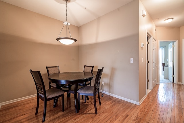 dining room featuring baseboards and light wood-type flooring