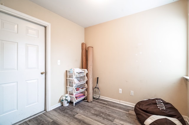 miscellaneous room featuring baseboards and wood finished floors