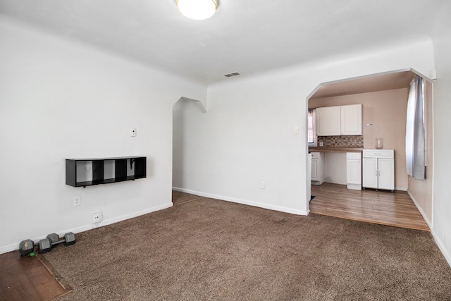26410 Beverly Rd, Taylor, MI 48180 - unfurnished living room with carpet flooring and arched walkways